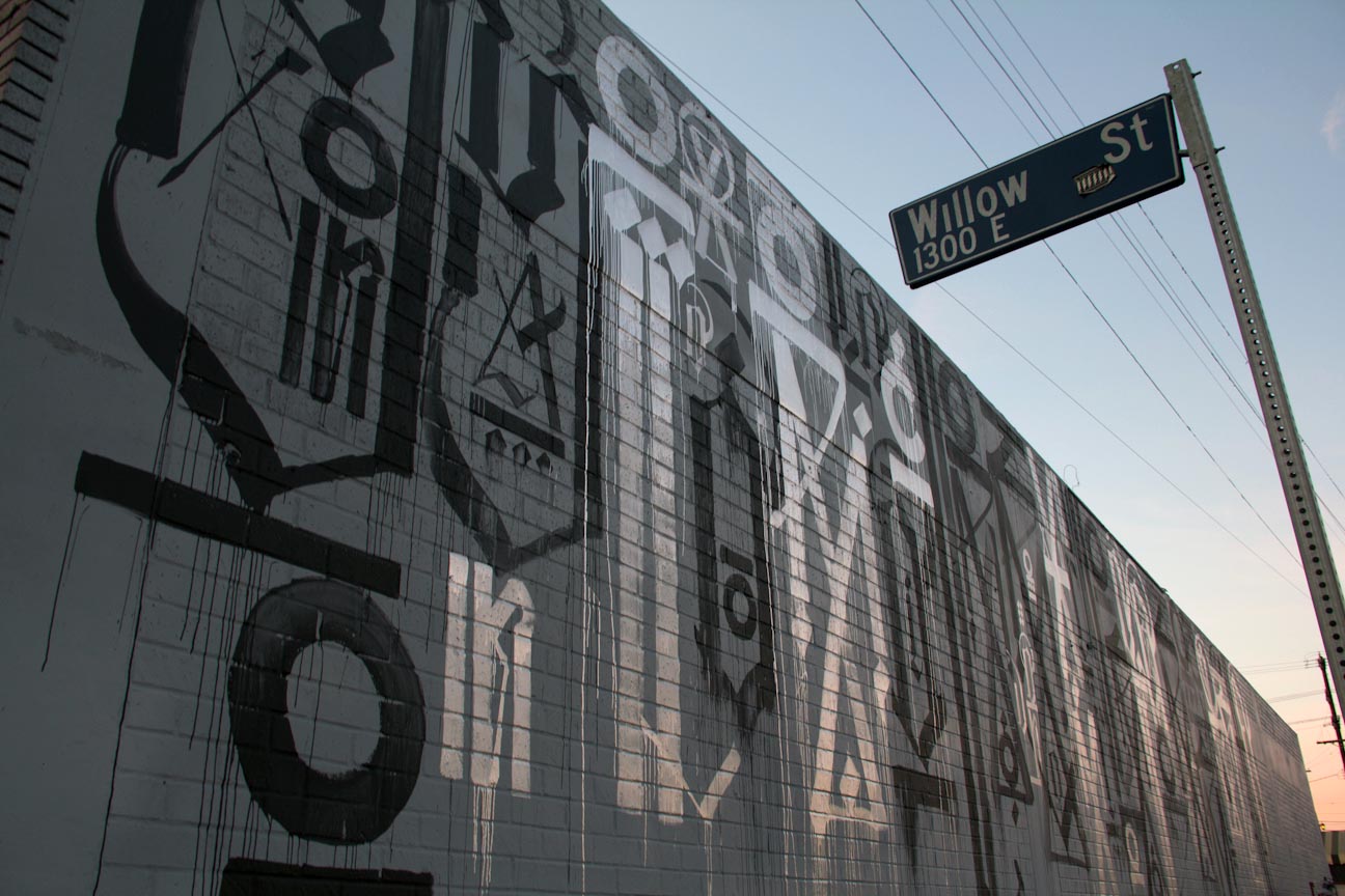 RETNA monochrome calligraphic mural — black and white script on urban wall
